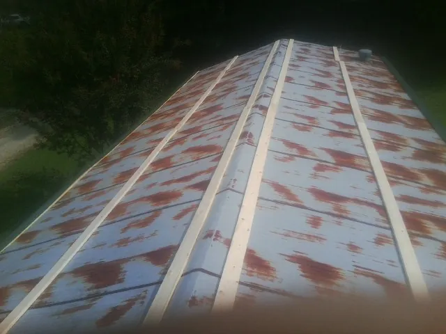 Rusted metal roof panels with new wood purlins before replacement — Storm Damage Roof Repair in Baldwin Park by Roofing Brothers