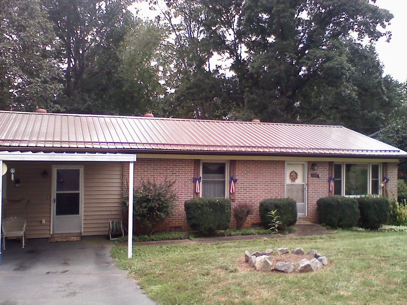 Bronze metal roof and carport on a brick ranch home — Roof Repair work by our crew in Baldwin Park